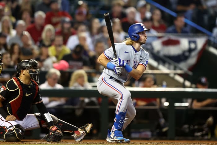 Oct 31, 2023; Phoenix, Arizona, USA; Texas Rangers left fielder Travis Jankowski (16) hits a two run double against the Arizona Diamondbacks during the third inning in game four of the 2023 World Series at Chase Field. Mandatory Credit: Mark J. Rebilas-USA TODAY Sports